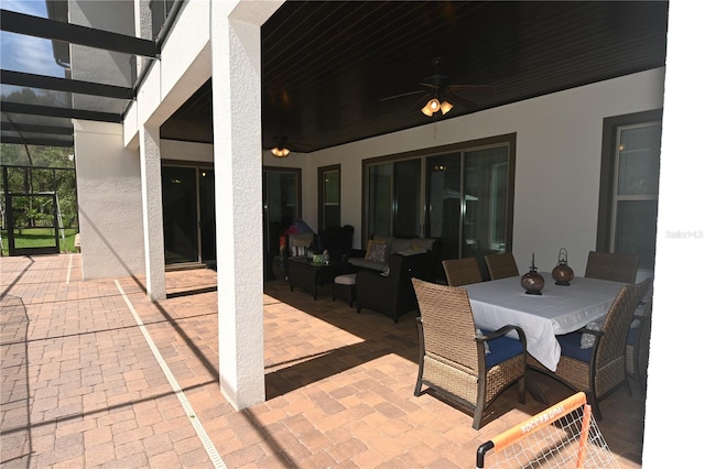 view of terrace with ceiling fan and a lanai