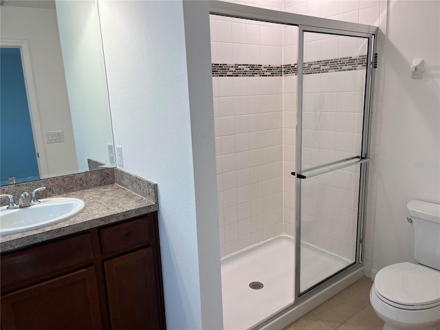 bathroom with oversized vanity, toilet, walk in shower, and tile flooring