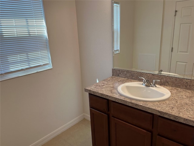 bathroom with plenty of natural light, tile floors, and oversized vanity