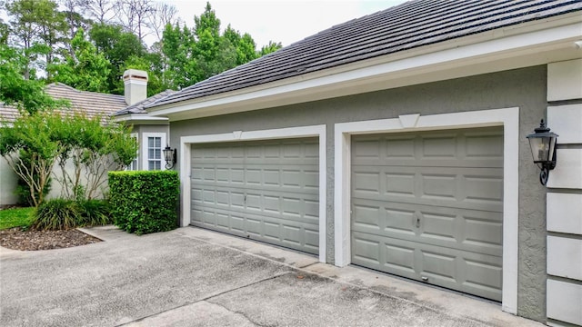 garage with concrete driveway