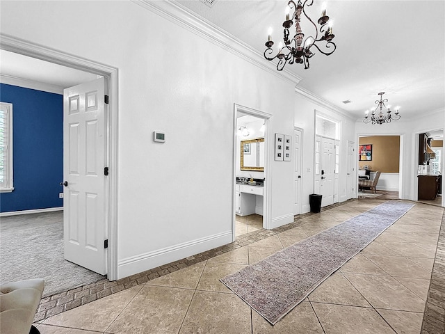 corridor with a healthy amount of sunlight, light tile patterned floors, ornamental molding, and an inviting chandelier