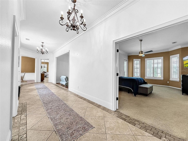 hall featuring light carpet, a chandelier, and ornamental molding