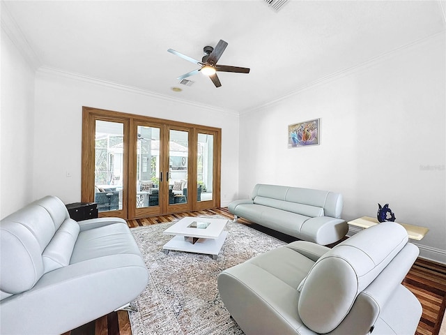 living room featuring hardwood / wood-style floors, ceiling fan, and crown molding