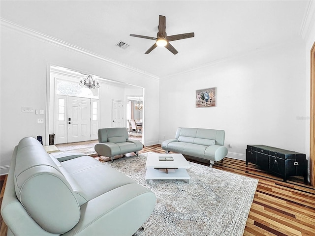 living room with ceiling fan with notable chandelier, wood-type flooring, and crown molding