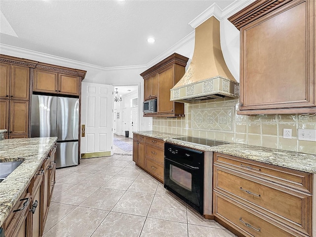 kitchen with premium range hood, black appliances, crown molding, light stone countertops, and light tile patterned floors