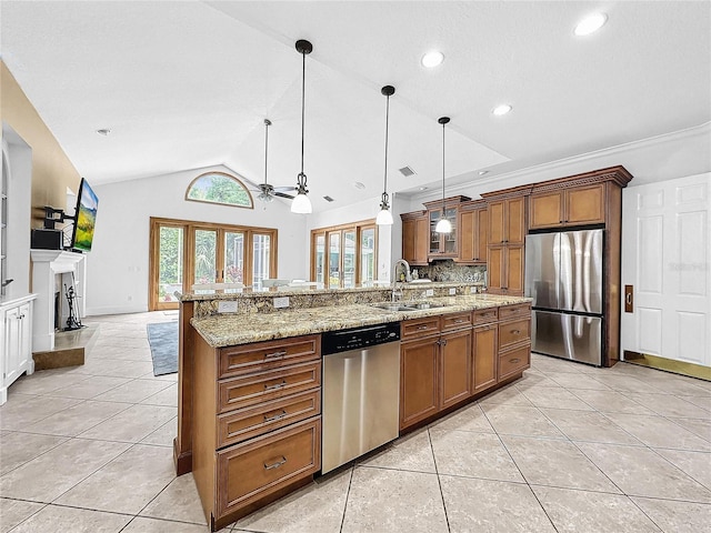 kitchen with appliances with stainless steel finishes, vaulted ceiling, ceiling fan, light tile patterned floors, and pendant lighting