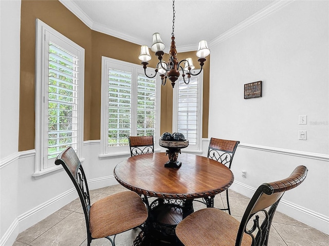 tiled dining space with a healthy amount of sunlight, ornamental molding, and a chandelier