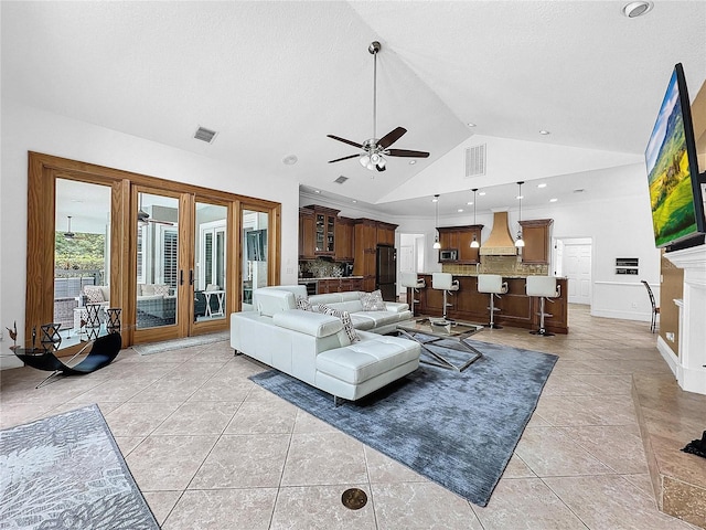 living room featuring ceiling fan, light tile patterned floors, high vaulted ceiling, and french doors