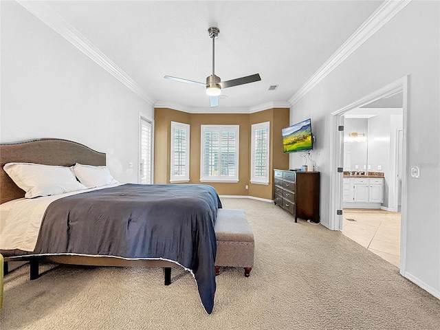 carpeted bedroom featuring ceiling fan, ensuite bathroom, and crown molding