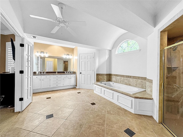 bathroom with vanity, plus walk in shower, vaulted ceiling, tile patterned flooring, and ceiling fan