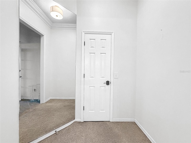 hallway with a textured ceiling, carpet floors, and crown molding