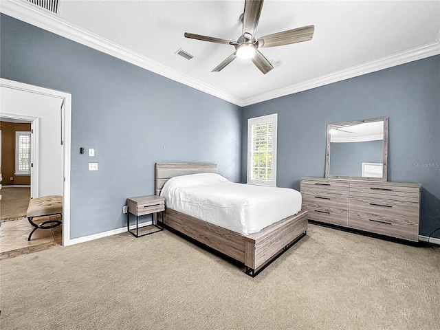 carpeted bedroom featuring ceiling fan and ornamental molding