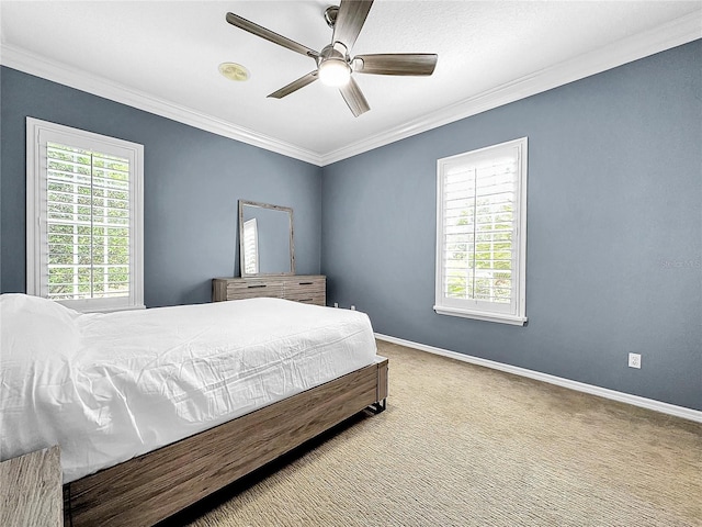 bedroom featuring carpet floors, ceiling fan, and crown molding