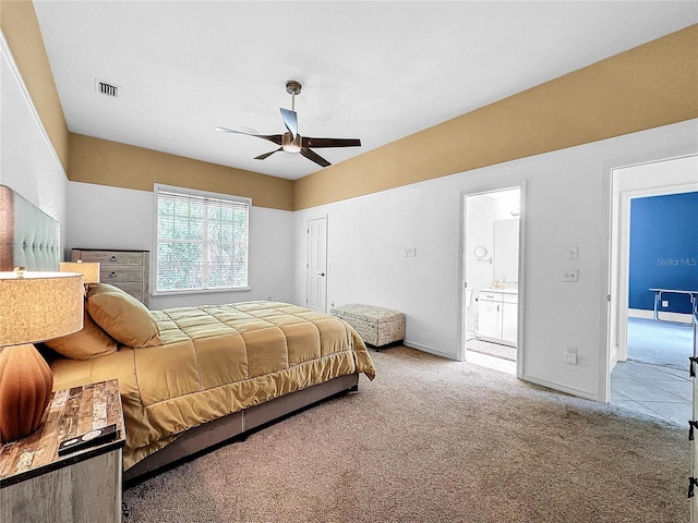 bedroom featuring ceiling fan, carpet floors, and ensuite bath