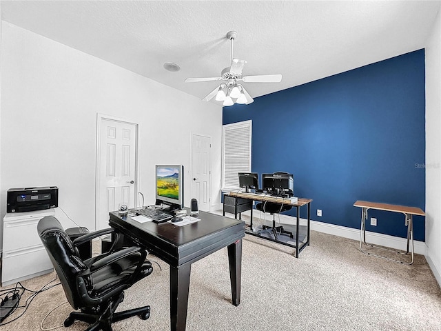 office area featuring a textured ceiling, light colored carpet, and ceiling fan