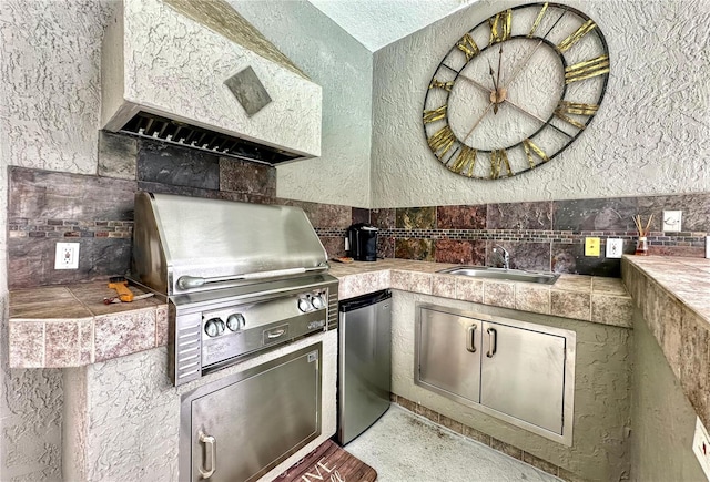 kitchen featuring stainless steel fridge and sink