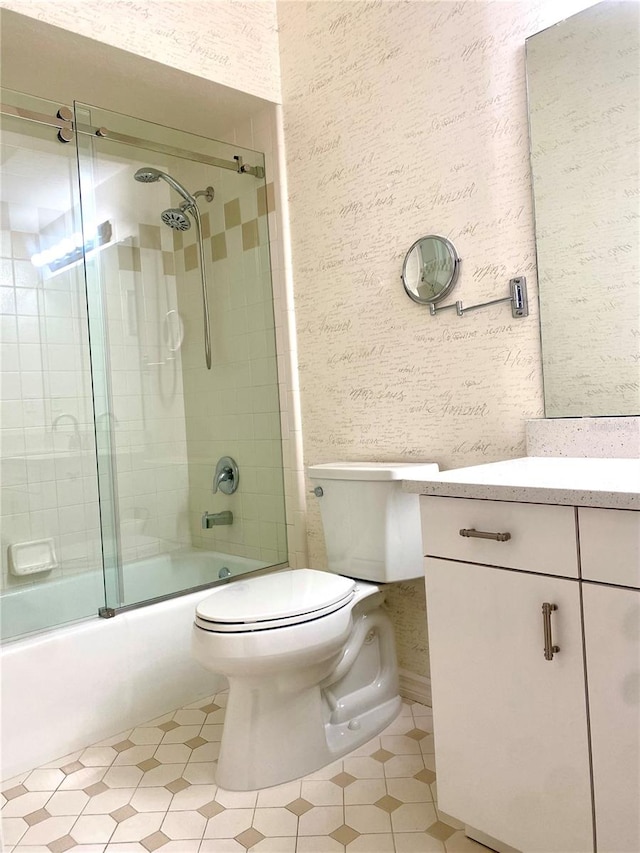 full bathroom with toilet, vanity, and combined bath / shower with glass door