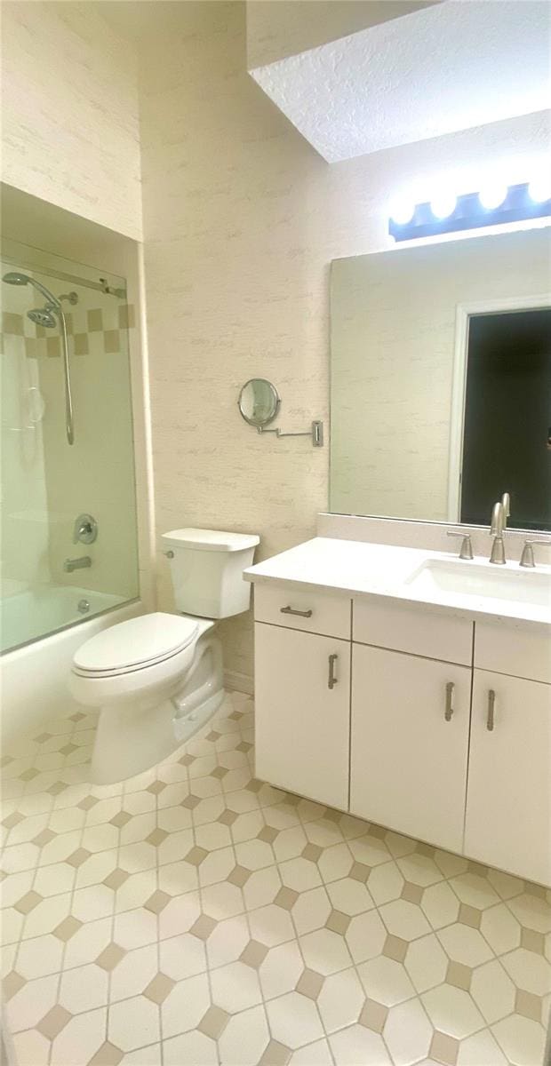 full bathroom with a textured ceiling, vanity, shower / bath combination, and toilet