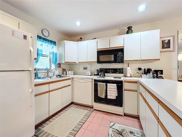 kitchen with light tile flooring, white appliances, white cabinets, and sink