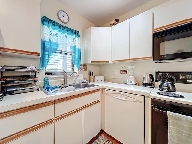 kitchen with white appliances, white cabinets, and sink