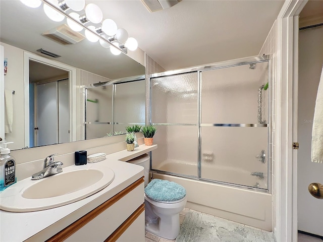 full bathroom with shower / bath combination with glass door, tile flooring, toilet, and large vanity