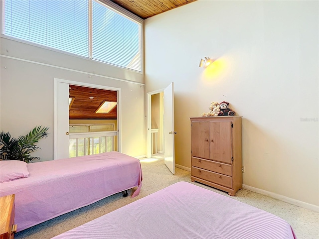 bedroom featuring high vaulted ceiling, wood ceiling, and light colored carpet