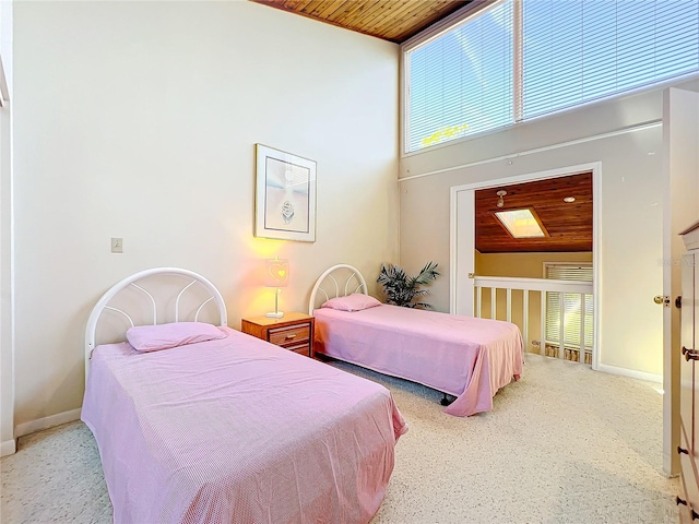 bedroom with light carpet, multiple windows, high vaulted ceiling, and wood ceiling