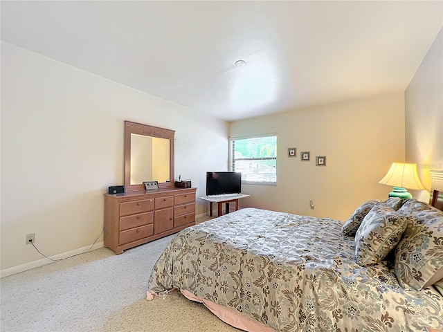 bedroom featuring light carpet