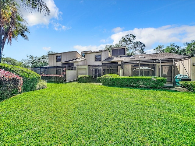 rear view of house featuring a lawn