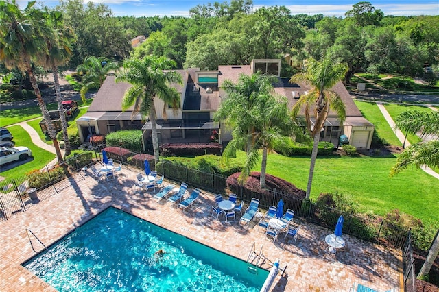 view of swimming pool featuring a yard and a patio