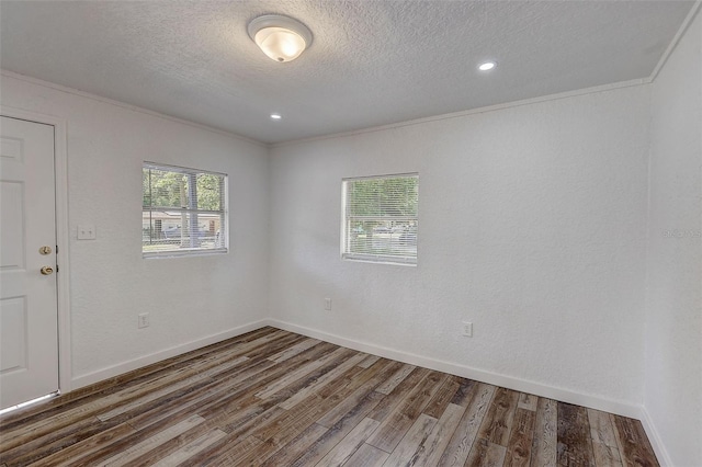 unfurnished room with crown molding, a textured ceiling, and dark hardwood / wood-style floors