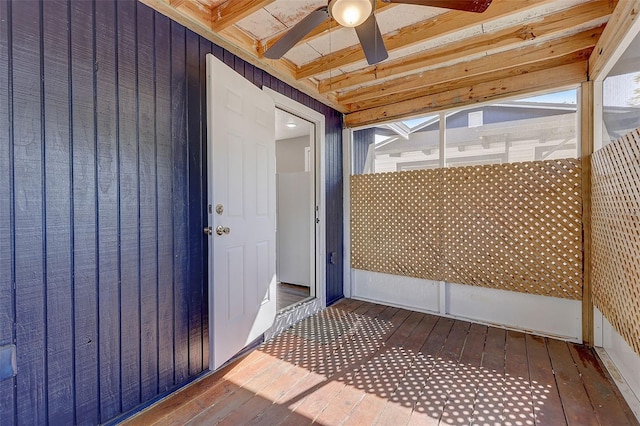 unfurnished sunroom with ceiling fan