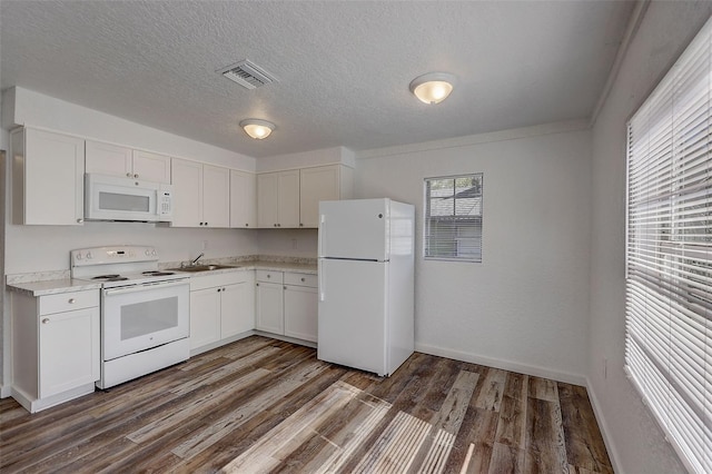 kitchen featuring white appliances, dark hardwood / wood-style flooring, white cabinets, and a textured ceiling