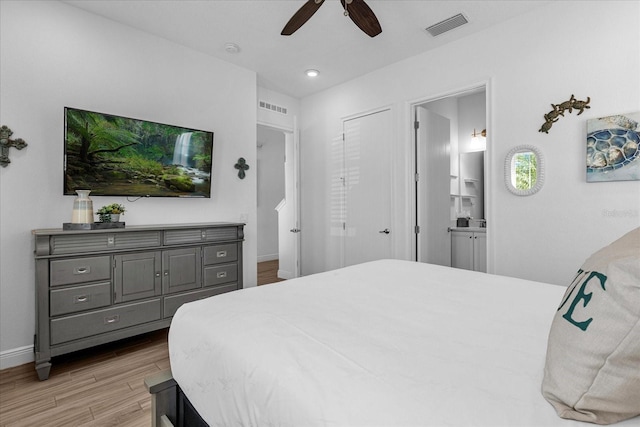 bedroom featuring connected bathroom, light hardwood / wood-style floors, and ceiling fan