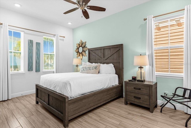 bedroom with ceiling fan and light wood-type flooring