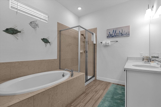 bathroom with separate shower and tub, vanity, and hardwood / wood-style flooring