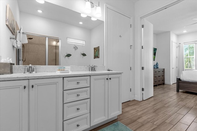 bathroom featuring double sink vanity and hardwood / wood-style flooring