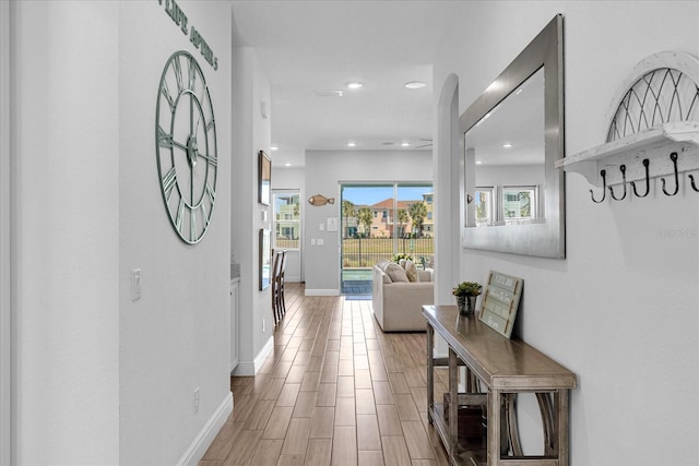 corridor with hardwood / wood-style flooring