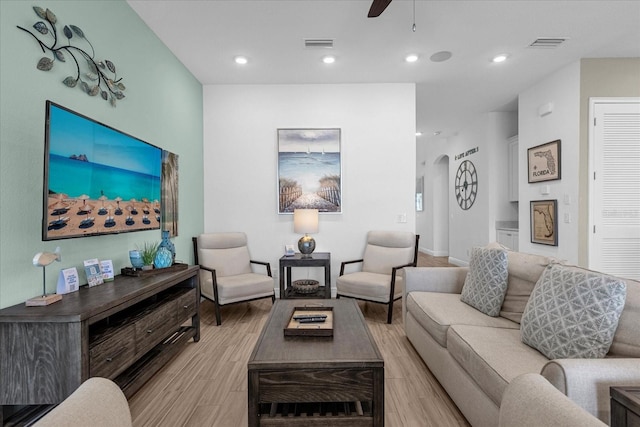 living room featuring ceiling fan and light hardwood / wood-style floors