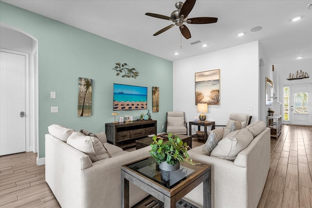 living room with ceiling fan and light hardwood / wood-style floors