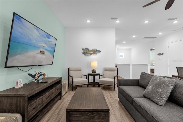 living room with ceiling fan and light wood-type flooring