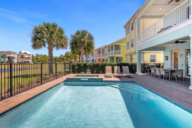 view of pool with an in ground hot tub, ceiling fan, and a patio area