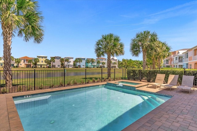 view of swimming pool featuring an in ground hot tub and a patio