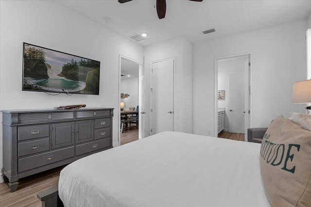 bedroom with connected bathroom, ceiling fan, and light wood-type flooring