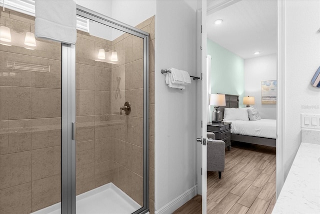 bathroom featuring wood-type flooring and a shower with shower door