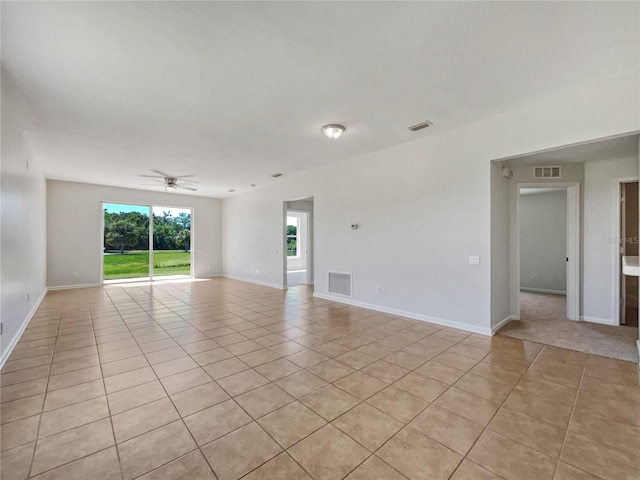 unfurnished room featuring ceiling fan and light tile floors