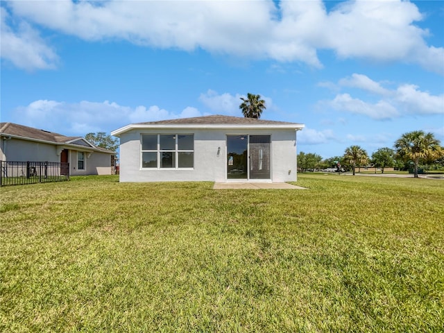 back of property featuring a lawn