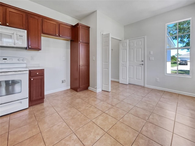 kitchen with white appliances and light tile flooring