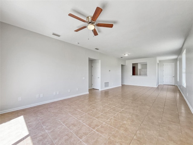 unfurnished living room featuring light tile floors and ceiling fan