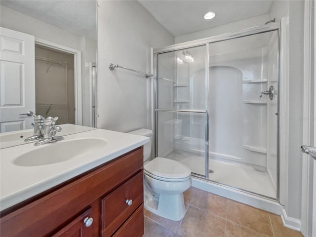 bathroom featuring tile floors, walk in shower, toilet, and vanity